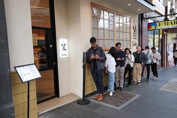 A queue forms outside Ginza Kagari on Russell Street.