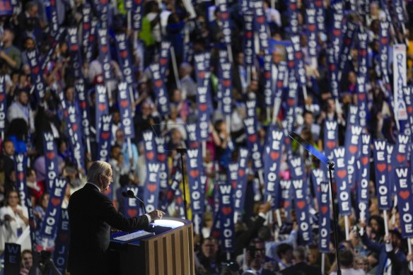 Delegates wave signs for US President Joe Biden.