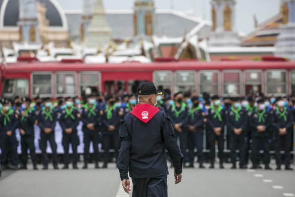 Police officers wearing face masks stand in line, protecting the area surrounding the Grand Palace during a protest in Bangkok last month.