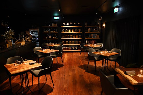 The subdued lighting of the polished dining room.