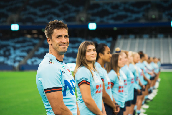 Waratahs captain Jake Gordon pictured with NSW women’s skipper Piper Duck and her teammates.
