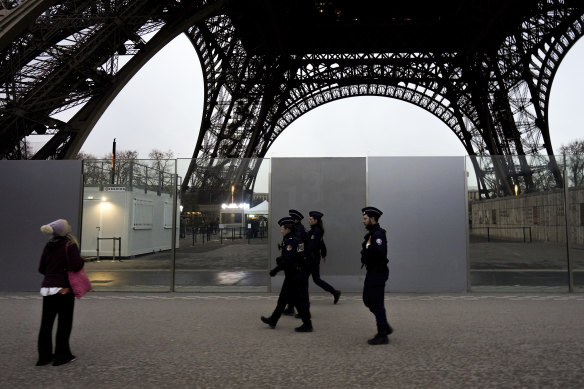 French police patrol near the Eiffel Tower in Paris.