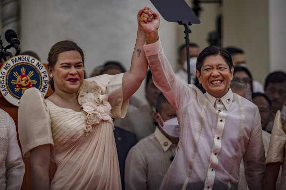 The new President Ferdinand Marcos jnr poses with new Vice President Sara Duterte after his swearing-in ceremony.