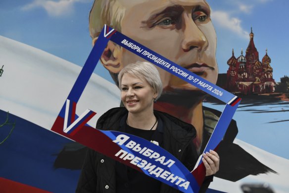 A woman poses with a frame with the words “I have chosen the president” after voting at a polling station in Donetsk, the Russian-controlled region of eastern Ukraine.