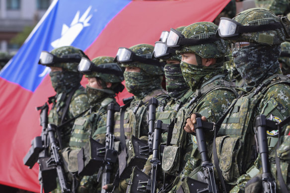 Taiwanese soldiers pose with a Taiwan flag after a preparedness enhancement drill in January simulating the defence against Beijing’s military intrusion.