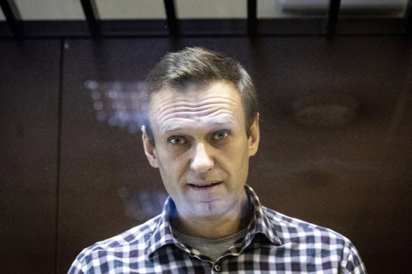 Russian opposition leader Alexei Navalny looks through a glass cage during a court appearance in 2021.