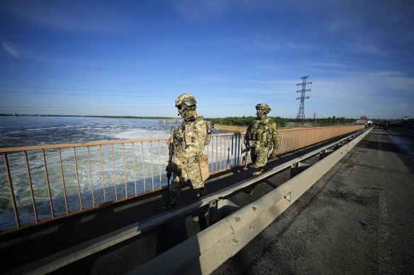 Russian troops patrol an area at the Kakhovka Hydroelectric Station, a run-of-river power plant on the Dnieper River in Kherson region, south Ukraine, in May.