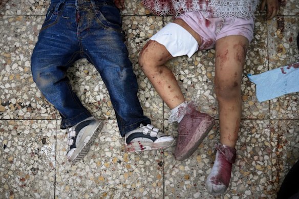 The bodies of two children lie on the hospital floor after the Israeli strike where people were waiting to receive nutritional supplements at a Project Hope-run medical clinic in Deir al-Balah on Thursday.