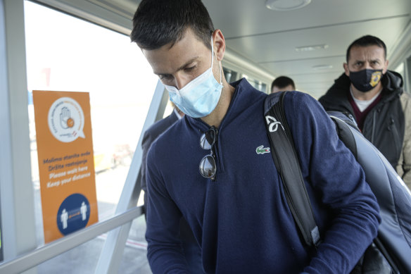 Novak Djokovic looks at his documents after landing in Belgrade in January.