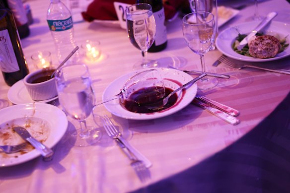 An abandoned wine glass sits in a bowl after guests were forced to evacuate.