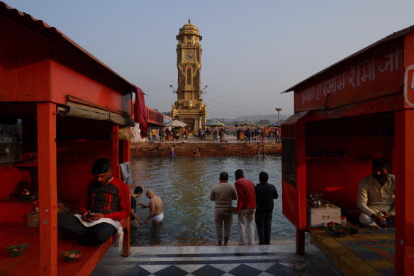 The largest religious gathering int the world: Hindu pilgrims take dips in the river Ganges.