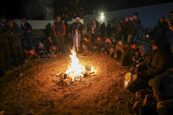 Relatives and friends of Palestinian prisoners to be released from Israeli prison wait around a bonfire for their arrival in Khan Younis, in the southern Gaza Strip.