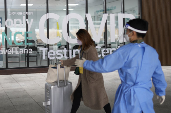 A woman arriving from China enters a COVID-19 testing centre at the Incheon International Airport In Incheon, South Korea.