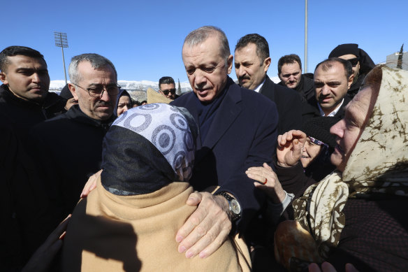 Turkey’s President Recep Tayyip Erdogan and a survivor speak as he visits the city centre destroyed by an earthquake in Kahramanmaras, southern Turkey.