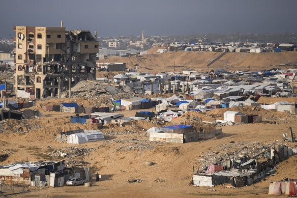 A tent camp for displaced Palestinians is set up amid destroyed buildings in the Khan Younis refugee camp.
