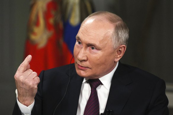 Russian President Vladimir Putin gestures while speaking during an interview with former Fox News host Tucker Carlson at the Kremlin.
