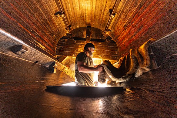 Jason I’Anson at work with deer skins inside a barrel at Greenhalgh Tannery.