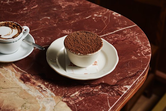 Tiramisu is served in a coffee cup.
