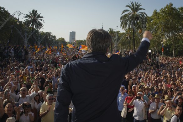 Catalan independence leader Carles Puigdemont addresses supporters after his arrival near the Catalan parliament to allegedly attend the investiture debate in Barcelona.