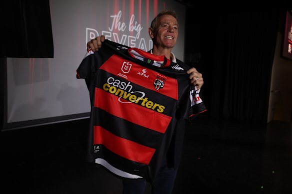 North Sydney legend Greg Florimo holds up the new Perth Bears jersey.