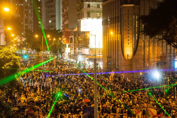 Pro-democracy protesters shine laser pointers during a clash at Admiralty district in Hong Kong on August 31.