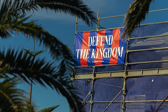 A banner supporting the Newcastle Knights is strung across the scaffolding of a house under construction at the start of the Newcastle Memorial Walk.