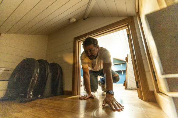 An auction attendee inspecting the attic at 42 Goodwin Street. 