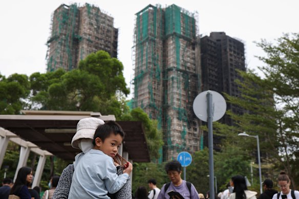 Affected resident Ms Kwok and her son revisit the site of their now-destroyed home.