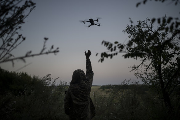 A Ukrainian drone pilot reaches for a reconnaissance drone in the Luhansk Region, Ukraine.
