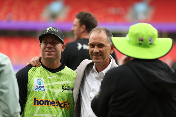 Happier times: David Warner and Justin Langer share a moment before the opener was removed for a duck.  