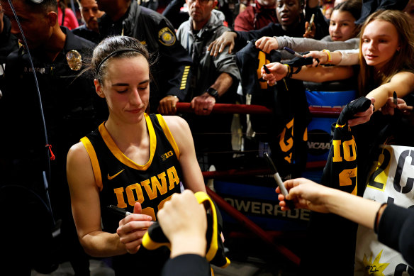 Iowa’s Caitlin Clark signs autographs after a win over Minnesota.