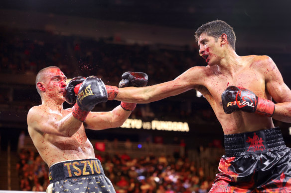  Tim Tszyu (L) takes a punch from Sebastian Fundora during the ninth round of a title fight at Las Vegas, Nevada. 