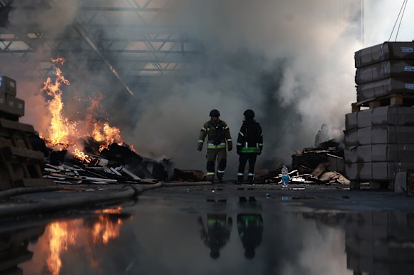 Workers extinguish a fire after a Russian drone strike in Zaporizhzhia, Ukraine.