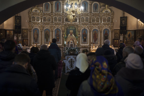 Ukrainians attend a Christmas Mass at an Orthodox Church in Bobrytsia, on the outskirts of Kyiv, Ukraine, on December 25, 2022. 