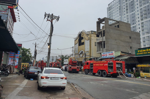 Fire department trucks line outside a karaoke club following a fire in Thuan An city, southern Vietnam.