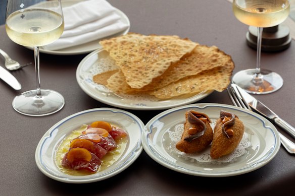 Clockwise from top: a side of pane carasau; mozzarella in carrozza; yellowfin tuna crudo with fennel and bottarga dressing.