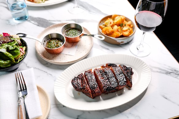 Tajima wagyu striploin with beef-fat potatoes, a leaf salad, steak sauce and red pepper chimichurri. 