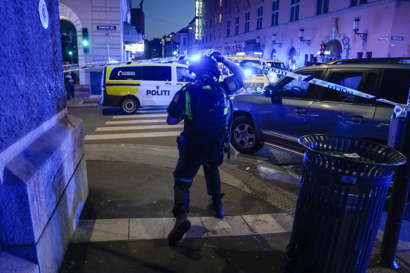 Police gather at the site of a mass shooting in Oslo, early on Saturday.