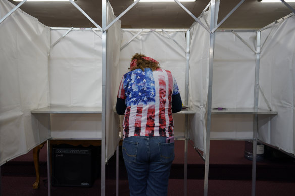 Loretta Myers fills out her ballot at her polling place, the New LIFE Worship Centre Church of God, in Fayetteville, Pennsylvania.