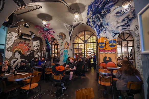 Bar Ampere's concrete tunnel swept with bohemian artworks.