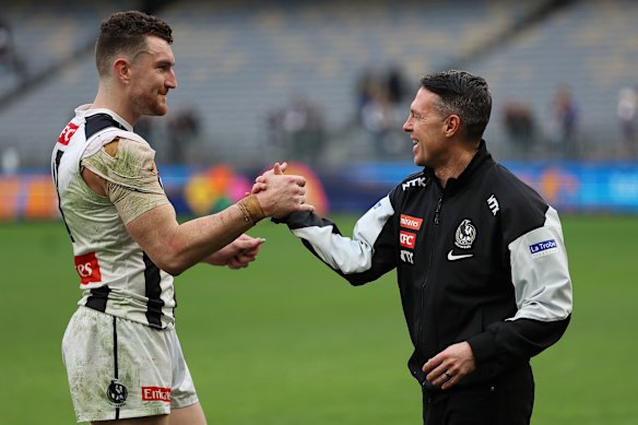 Craig McRae (right) embraces Dan McStay after the undermanned Magpies’ win over the Eagles in Perth.
