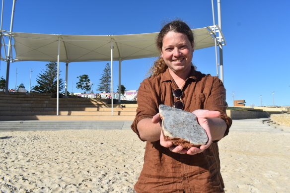 Scarborough is a tranquil haven for FIFO worker and geologist Bruno Pereira, pictured with a sample of lithium bearing rock from the Pilbara 
