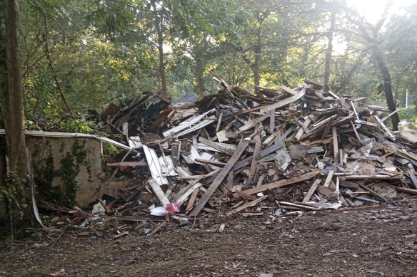 In this photo provided by Susan Hodgson, her mistakenly demolished family home sits in a pile of lumber and debris in southwest Atlanta, Georgia.