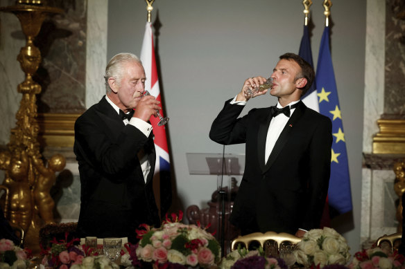  French President Emmanuel Macron, right, and Britain’s King Charles III toast during a state dinner in the Hall of Mirrors at the Chateau de Versailles in Versailles last year.