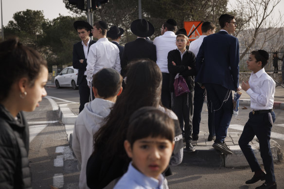 People visit the place where seven Israelis were killed in a shooting attack in East Jerusalem. 