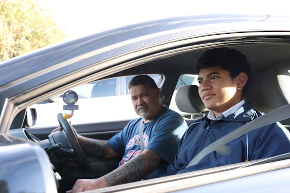 “What’s going on with this bloody world?“: Al Ioane and son AJ outside the school on Wednesday.