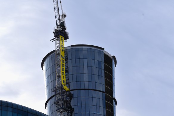 The banner on the crane next to Woodside’s Perth headquarters on Tuesday morning.