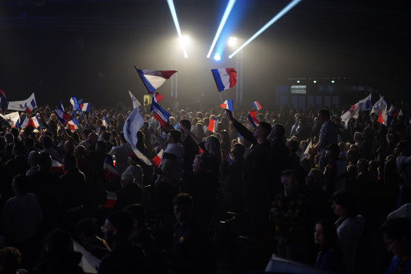 Supporters of French far-right leader Marine Le Pen wave French flags during a campaign rally in Perpignan, southern France.