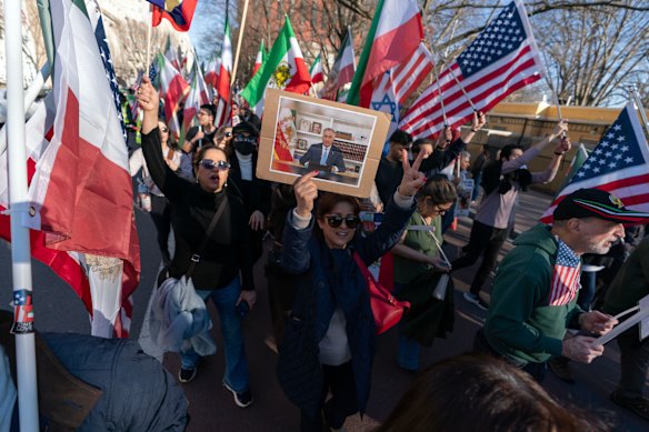 Demonstrators carrying a photograph of Reza Pahlavi, the son of the former shah of Iran, protest against the Islamic republic in Washington, DC. 
