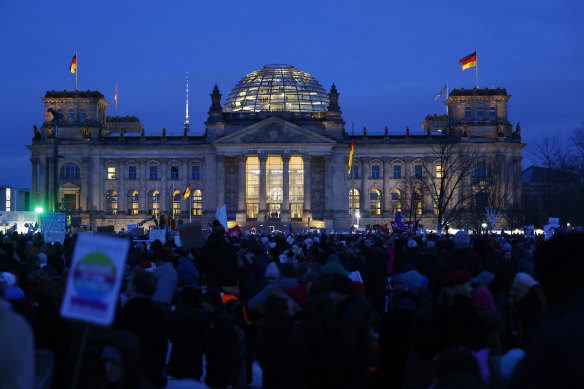 People gather in front of the Reichstag to protest against the far-right Alternative for Germany (AfD) political in Berlin.